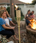 Easy Pour 12 Pack Bamboo Torch Set With Classic Weave Brown Finish Outdoor Lawn Patio Garden Lighting by a fire pit
