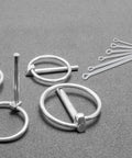 Stainless Steel Cotter Pin Assortment Kit for Automotive Gearheads and Trailer Hitch Projects with locking pins on gray surface