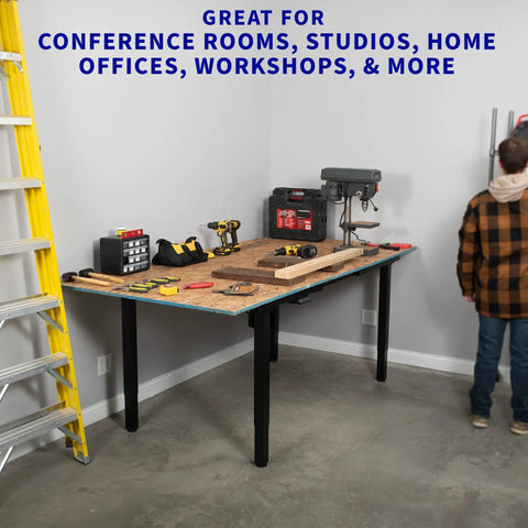 Heavy Duty VIVO 4 Leg Black Electric Dual Motor Standing Desk Frame For 60-130 Inch Tops, Solid Height Adjustable Sit Stand Base Table Support Platform in a workshop setting with tools.