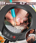 Close-up of 10X Magnifying Lamp with light and stand showing hands using diamond painting tool through 4.3-inch glass lens.