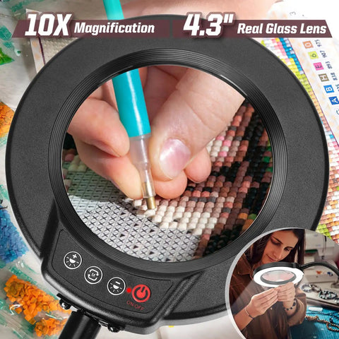 Close-up of 10X Magnifying Lamp with light and stand showing hands using diamond painting tool through 4.3-inch glass lens.