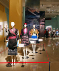 Exhibit featuring mannequins in traditional clothing with signage and Premium 2 Pack Crowd Control Stanchions with 6.5 Foot Red Retractable Belts.