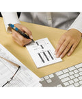 Person using Sticky Grid Notes 4x6 Inches, 6 Pads With 50 Sheets Each, White Paper With Blue Grid, on desk next to keyboard and papers.