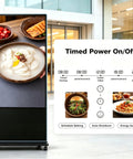 Top Shelf 65 Inch 4K UHD IPS Digital Signage Kiosk displaying food images and timed schedule for advertising use.