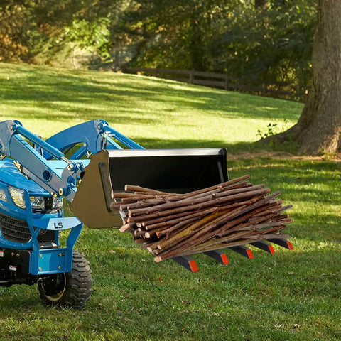 Blue tractor with Clamp On Debris Forks For 48 Inch Bucket With 5 Fork Tines and Stabilizer Bar hauling branches in a field