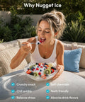 Woman enjoying a bowl of fruit with nugget ice; Grab And Go Countertop Nugget Ice Maker Churning Crisp Sonic Pellet Chips Up To Forty Pounds Daily, Four Minute Rapid Freeze, Sturdy Carry Handle, Total Game Changer For Lazy Sundays And Backyard Kickbacks.