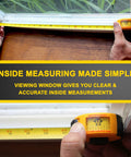 Person using Yellow 10 Ft Steel Tape Measure With Easy To Read Fractional Markings In Feet And Inches A Handy Tool For Measuring Windows Doors And Cabinets Inside And Outside Measurements on window frame