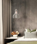Modern Industrial Farmhouse 6.5 Inch Hand Blown Seeded Glass Pendant Light in bedroom with washed copper finish over bed.