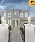 Dusk To Dawn Outdoor Post Light With Pier Mount Base illuminating a rainy walkway, waterproof aluminum lantern head visible