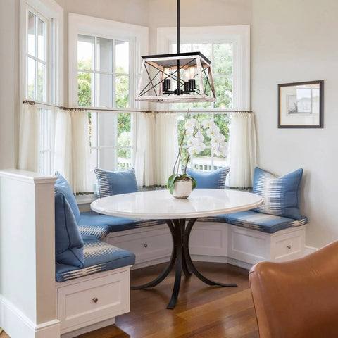 Farmhouse Chandelier For Dining Room And Kitchen Island Rustic White Wood Pendant Light hangs over a breakfast nook with blue cushions.