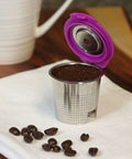 Stainless Steel Reusable K Cup 2 Pack With Built In Metal Filter For Keurig 1.0 2.0 KDuo KMini And More Eco Friendly Refillable Coffee Pod Delivers Rich Fresh Brew Every Time with coffee beans on a napkin