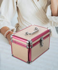 Sweet Aluminum Alloy Pedicure Rig With Layered Lockable Storage For Nail Techs And Makeup Pros To Keep Your Kit Clean And Secure While Hitting the Road For Home Or Office Jobs Without A Hassle, portable pink aluminum storage case on a table.