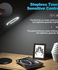 5X Rechargeable Magnifying Glass With Light And Stand next to a book on a wooden desk, highlighting touch control feature.