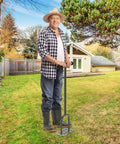 Man using Manual Lawn Aerator Spike Tool With 15 Stainless Steel Spikes Non Slip Grip Handle Grass Aerator For Loosening Soil And Boosting Lawn Health Durable Garden Aeration Tool For Easy Home Lawn Care on a sunny day in a backyard
