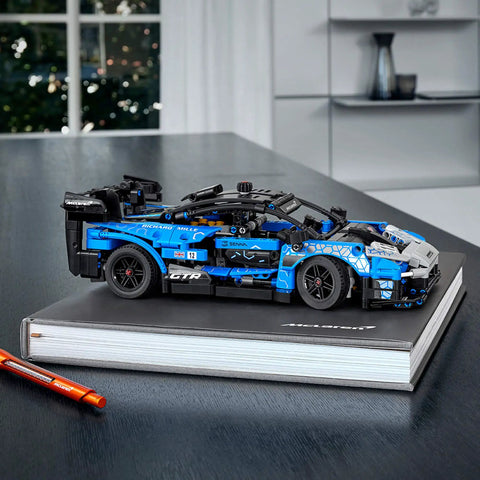 Technic McLaren Senna GTR 42123 Racing Collectible Model Car Build Kit displayed on a black book with orange pen nearby