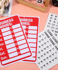 Two Piece Open Closed Sign Kit For Glass Doors And Windows In Bright Red And White, Hours Of Operation Signs for businesses displayed on a table