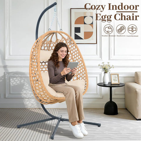 Cozy Hanging Egg Chair With Stand And Plush Cushions for Indoor Outdoor Chill Sessions, all-weather rattan swing seat viewed indoors.