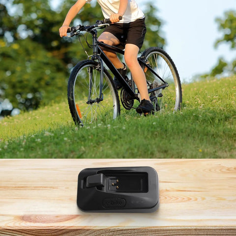 Bike Battery Charger For Etap And AXS Electronic Shifting, Dropper Seatpost Batteries in black ABS construction on wooden surface.