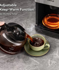 10 Cup Grind And Brew Coffee Maker Featuring A Sleek Touch Display, Programmable Schedule, Custom Grind Levels, Smooth Sip Keep Warm, And Hassle Free Set It Forget It Automation For Daily Caffeine Cravings pouring fresh coffee into a cup from a glass carafe.