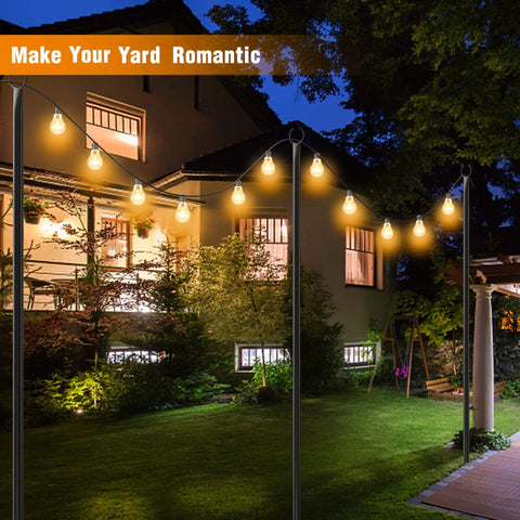 Outdoor String Light Poles 8.9-Foot Tall, 4 Pack With 5-Prong Stakes illuminated in garden at night