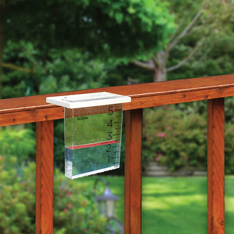 Easy Mount Waterfall Rain Gauge With Slide On Bracket Deck Or Fence Rail Compatible Backyard Rain Monitor Up To Six Inches Durable Plastic Frame Wide Waterfall Design Easy Install And Readout installed on wood fence rail in garden