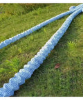 Perforated Landscape Drainage Tubing With No Clog Nonwoven Filter Sleeve And Spiral Steel Wire DIY Friendly Flexible French Drain Hose For Yard Basement Road Lawn Diameter 10 Cm 3.9 In Length 5 Ft 1.5 M shown laid out on grass