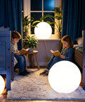 Children reading by 16 Inch Rechargeable LED Globe Light With Remote, indoors, warm glow, creating a cozy ambiance.