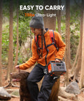 Person holding Portable Power Station Explorer 300 292Wh LiFePO4 Battery Solar Generator for outdoors camping in forest
