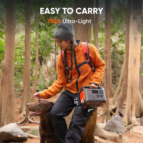 Person holding Portable Power Station Explorer 300 292Wh LiFePO4 Battery Solar Generator for outdoors camping in forest