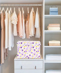Top Tier Foldable Storage Bin With Sturdy Side Grips For Bedroom Organization Durable Oxford Fabric Collapsible Crate With Snug Flip Lid To Keep Your Room Clutter Free on shelf in a closet with hanging clothes.