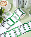 Roll of 400 Soccer Name Tag Stickers Set In Green And Black With 4 Designs Adhesive Label Decals on desk with plants