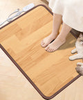 Person's feet on Cozy Feet Warmer Floor Mat With Ten Heat Settings And Timer, Fast Heating Under Desk Foot Pad, cat beside mat.