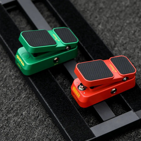 Red and green 2 In 1 Wah And Volume Pedal For Electric Guitars Mini Vintage Style with Smooth Wah Sweep on dark fabric background