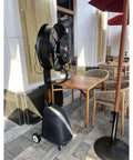 Badass Heavy Duty Industrial Misting Fan Crushes Summer Heat With High Velocity Airflow and Cold Water Fogging, positioned near patio seating.