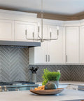 Camille 22 Inch Modern 5-Light Candle Style Chandelier with Open Frame in Brushed Nickel Finish illuminating kitchen area