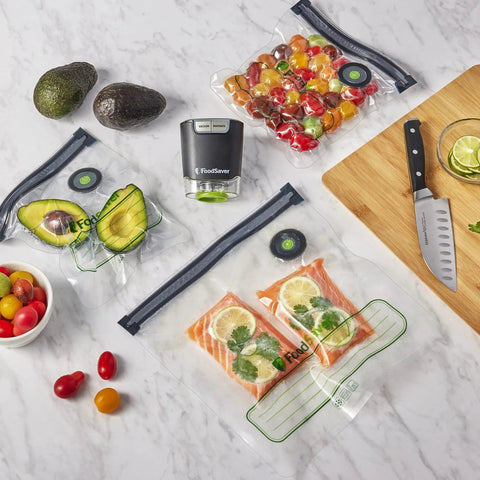 Reusable Quart Vacuum Zipper Bags, 10 Count, BPA Free, Microwave Safe on kitchen counter with veggies and knife.