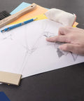 Hand using large dry cleaning pads for drafting art architecture and graphite erasers for smudge free drawings