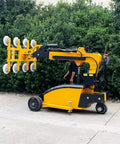 Hassle Free Glass Vacuum Lifter Robot With Smooth Gliding Action For Worry Free Large Panel Hoisting Plus Rapid Facade Installation And Rock Solid Industrial Load Moving Gear side view on outdoor surface with operator.