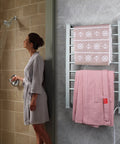 Eight Bar Towel Warmer With Timer for Bathroom and Laundry mounted with pink towels, 21.7 in wide and 33.5 in high.