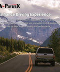 Rear view of a truck driving on a scenic road surrounded by mountains and trees, showcasing enhanced driving experience.