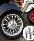 Image showing a motorcycle wheel with a focus on 4 Pack Brass Tire Valve Extenders 27mm Screw In Cap Extensions for cars, trucks, and motorcycles.