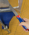 Person using 10 Inch Flat File With Anti Slip Grip For Sharpening Tools Deburring And Metal Work Durable Steel Double Cut On One Face And Single Cut On The Sides Ergonomic Handle Pro Grade Quality For Pros And Diy on metal edge