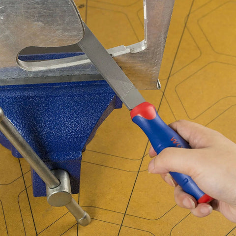 Person using 10 Inch Flat File With Anti Slip Grip For Sharpening Tools Deburring And Metal Work Durable Steel Double Cut On One Face And Single Cut On The Sides Ergonomic Handle Pro Grade Quality For Pros And Diy on metal edge