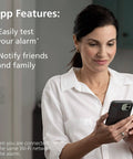 Woman using phone with app features of Smart Carbon Monoxide Detector And Indoor Air Quality Monitor 2 In 1 Plug In displayed