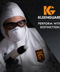 Person in protective suit wearing V30 Nemesis Foam Safety Glasses With Anti Fog Lenses Black Frame Unisex Eyewear.