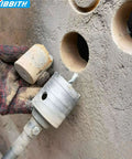 DKIBBITH 4-inch concrete hole saw with SDS Plus shank and tungsten steel core, drilling into cinder block