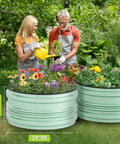 Two galvanized raised garden beds, green, 2x2x1 ft, filled with vegetables and flowers, outdoors, easy assembly, safe edge design.