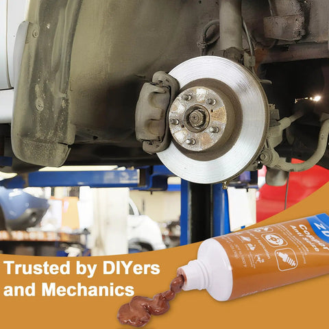 Copper Anti Seize Lubricant Paste With Brush Top Bottle being applied to brake rotor and pads in automotive repair setting.