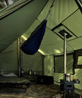 Interior view of Large Hammock Hot Tent With Stove Jack Waterproof And Windproof Winter Wall Tent showing a hammock, stove, and sleeping area.