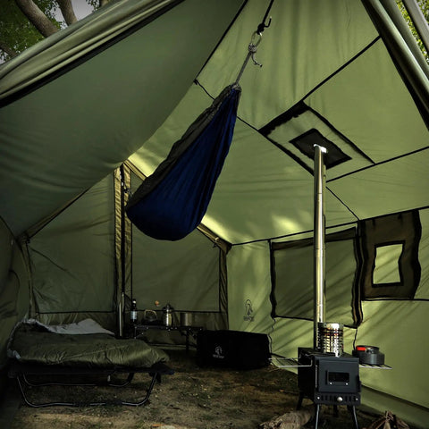 Interior view of Large Hammock Hot Tent With Stove Jack Waterproof And Windproof Winter Wall Tent showing a hammock, stove, and sleeping area.